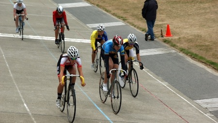The women's peloton during the Poneke Plate 8km Scratch Race at the Wellington Velodrome 2015. Sophie Bloxham​ (yellow and blue Levin skinsuit) went on to win.  Credit: PNP Cycling Club.
