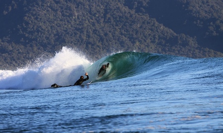 Surfing waves in Fiordland before heli-skiing.